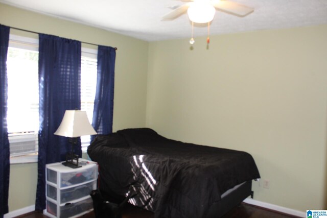 bedroom featuring ceiling fan and dark wood-type flooring