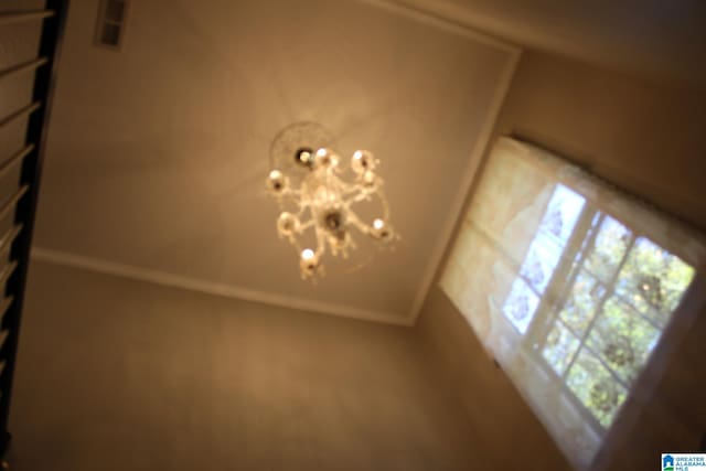 interior details featuring an inviting chandelier