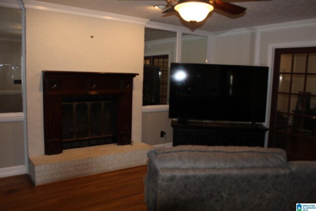 living room featuring dark hardwood / wood-style floors, ornamental molding, and ceiling fan