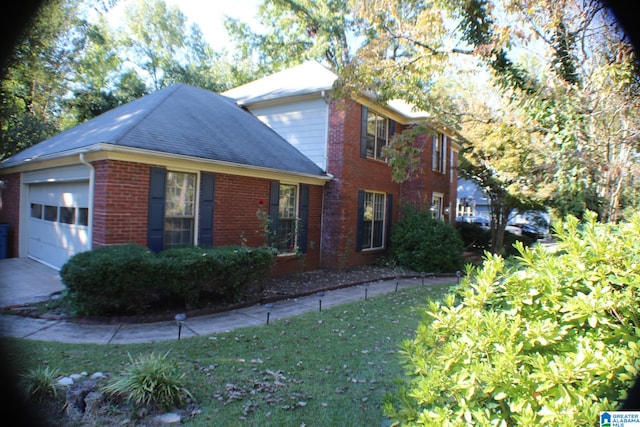 view of home's exterior featuring a yard and a garage