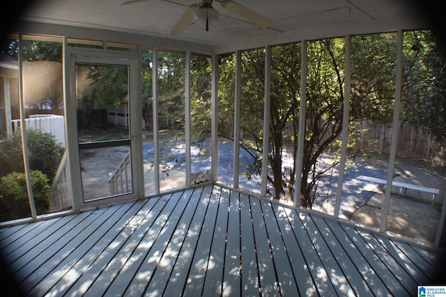 unfurnished sunroom with a healthy amount of sunlight and ceiling fan