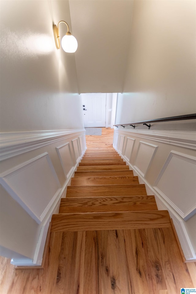 stairs with hardwood / wood-style floors