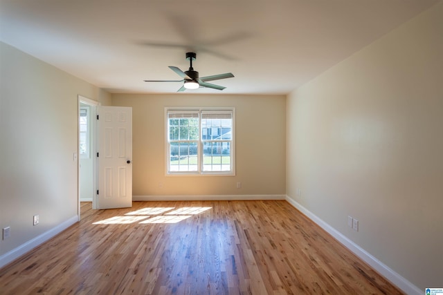 empty room with ceiling fan and light hardwood / wood-style flooring