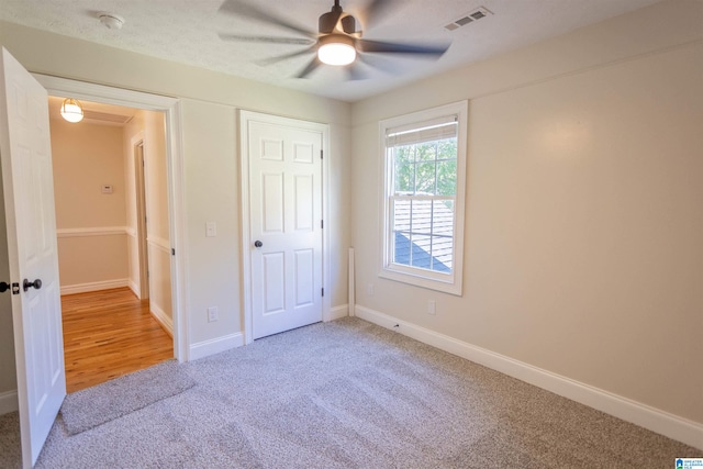 unfurnished bedroom with carpet floors and ceiling fan