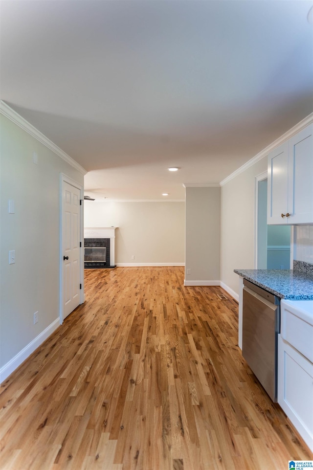 unfurnished living room with ornamental molding and light hardwood / wood-style flooring