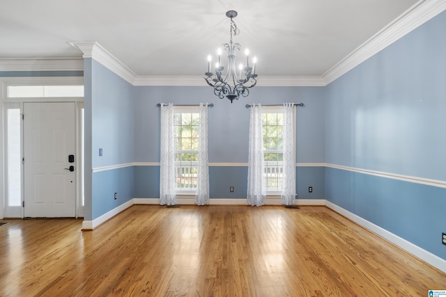 interior space with a notable chandelier, light hardwood / wood-style floors, and crown molding