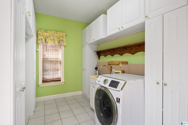 clothes washing area with washer / dryer, light tile patterned floors, cabinets, and sink