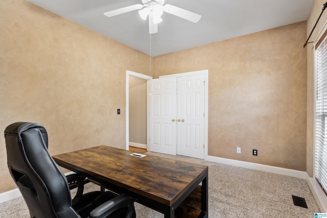 carpeted office featuring ceiling fan