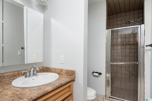 bathroom featuring vanity, toilet, tile patterned floors, and walk in shower