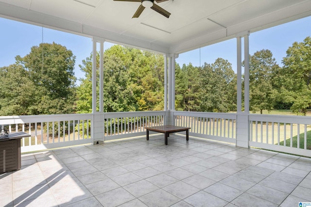 unfurnished sunroom with ceiling fan