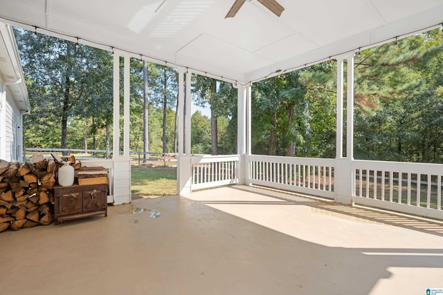 unfurnished sunroom featuring ceiling fan