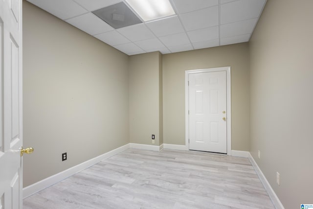 spare room with light hardwood / wood-style floors and a drop ceiling