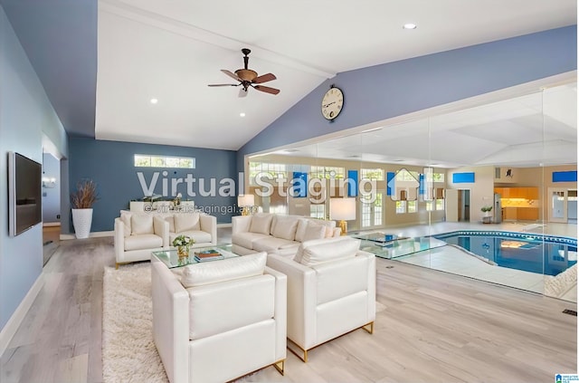 living room with lofted ceiling with beams, light hardwood / wood-style floors, and plenty of natural light