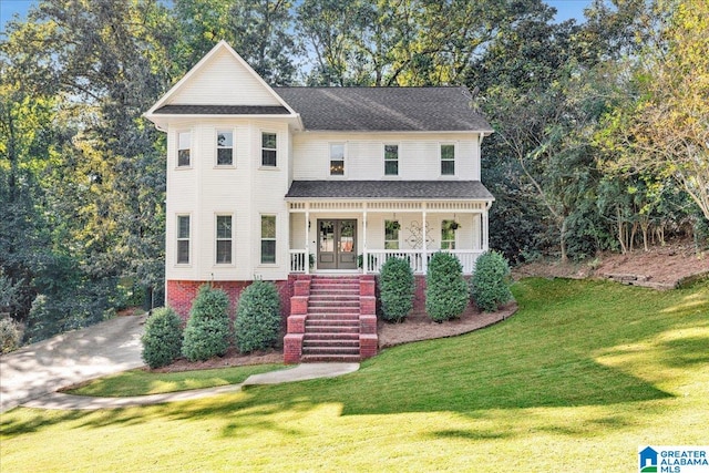 view of front of house featuring a front yard and covered porch