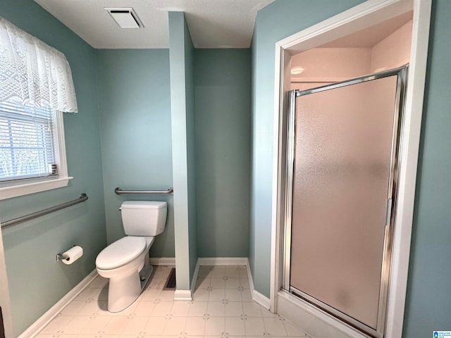 bathroom with toilet and an enclosed shower