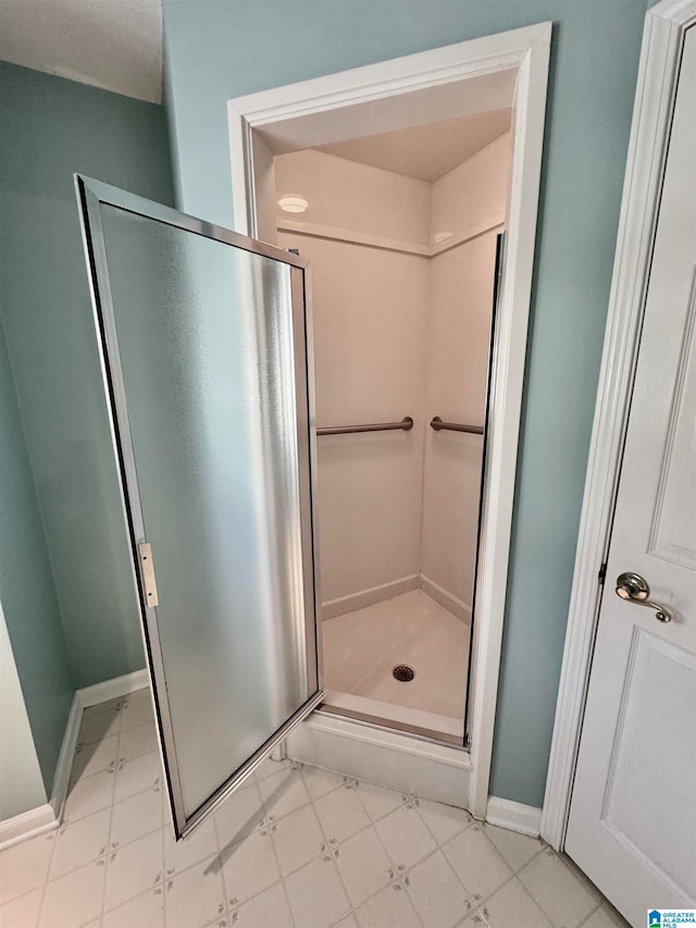 bathroom featuring a shower with shower door