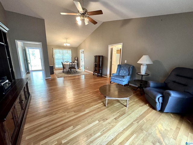 living room with high vaulted ceiling, light hardwood / wood-style flooring, and ceiling fan