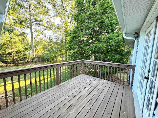 wooden terrace with a lawn