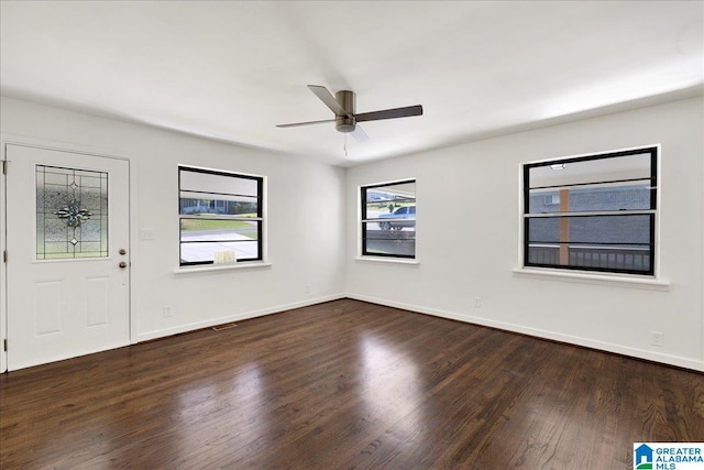 interior space featuring dark wood-type flooring and ceiling fan