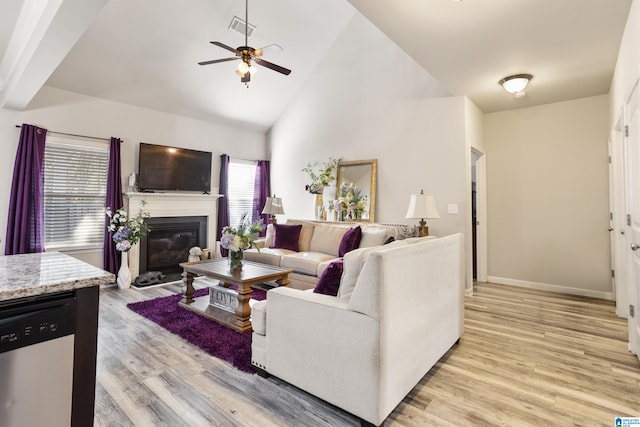 living room featuring light hardwood / wood-style flooring, high vaulted ceiling, and ceiling fan