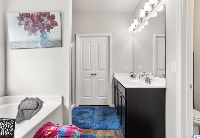 bathroom featuring vanity and toilet