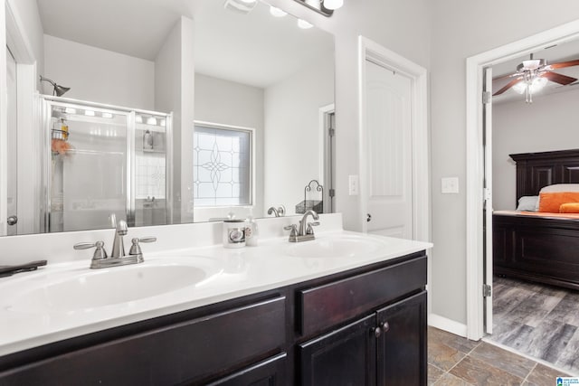 bathroom featuring vanity, ceiling fan, and a shower with shower door