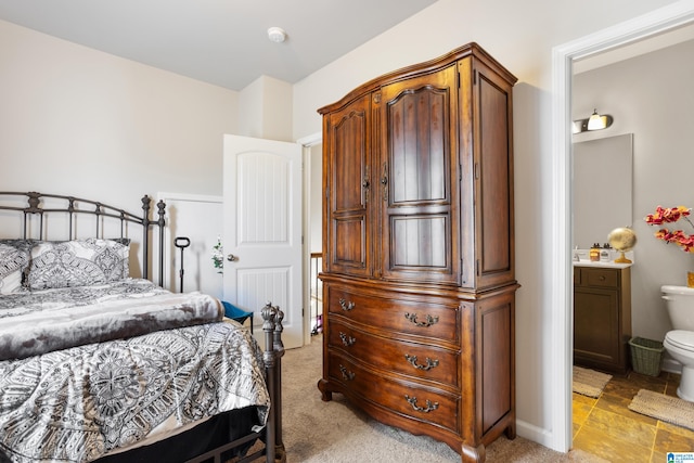 carpeted bedroom with connected bathroom