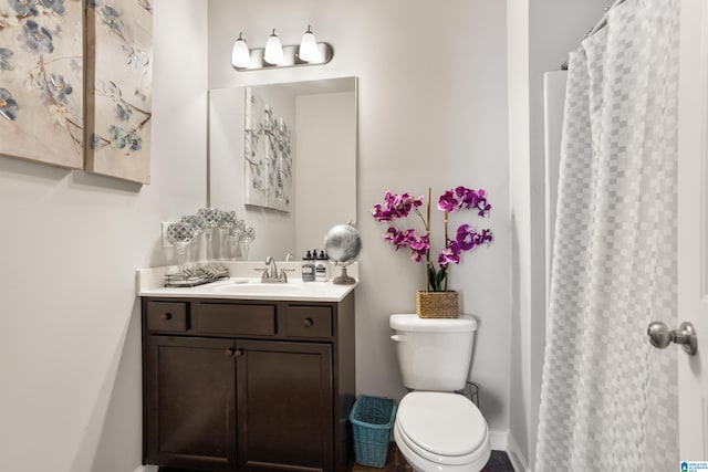 bathroom featuring vanity, toilet, and a shower with curtain