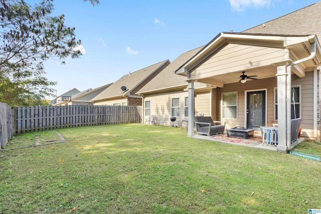 rear view of house with a yard, a patio area, and ceiling fan