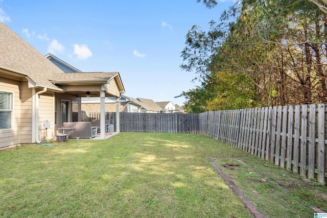 view of yard with a patio area and ceiling fan