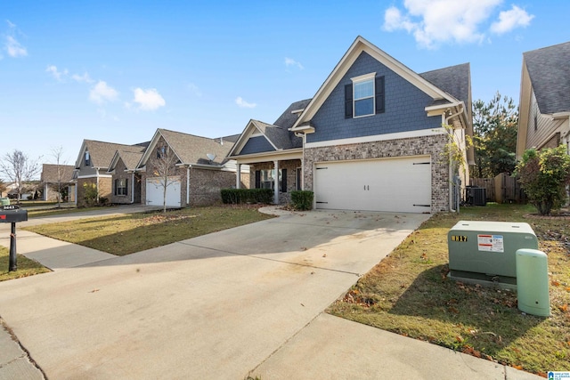 craftsman inspired home with a front yard, a garage, and central AC unit