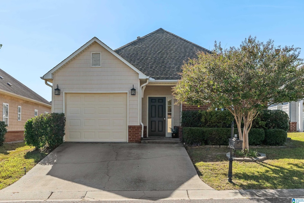 view of front facade with a front yard and a garage