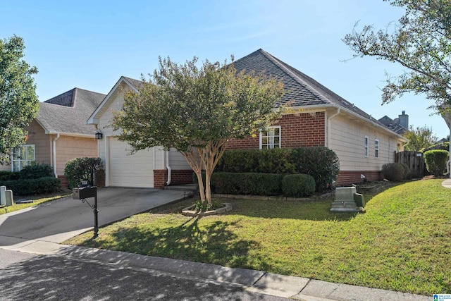 view of front of house featuring a garage and a front lawn