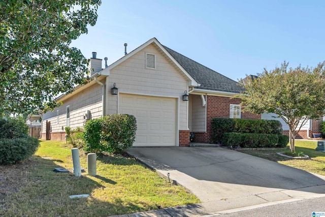 view of front of home with a front yard and a garage