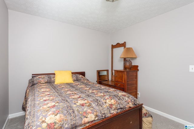 bedroom with carpet and a textured ceiling