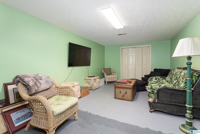 living room with concrete flooring and a textured ceiling