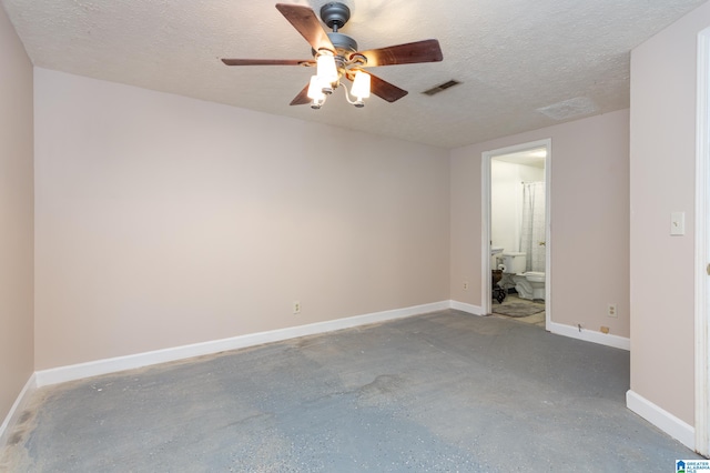 unfurnished bedroom with concrete flooring, connected bathroom, a textured ceiling, and ceiling fan