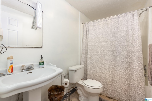 full bathroom with sink, toilet, and shower / tub combo with curtain