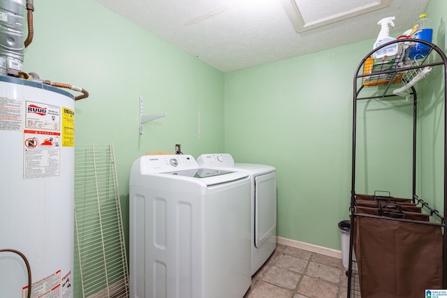 laundry area featuring washer and dryer, water heater, and a textured ceiling