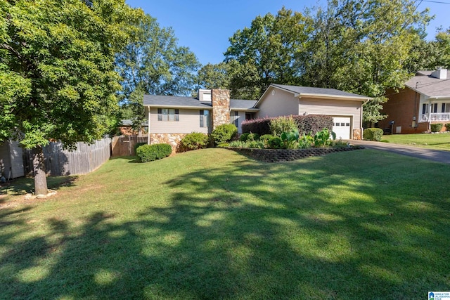 view of front facade with a garage and a front yard