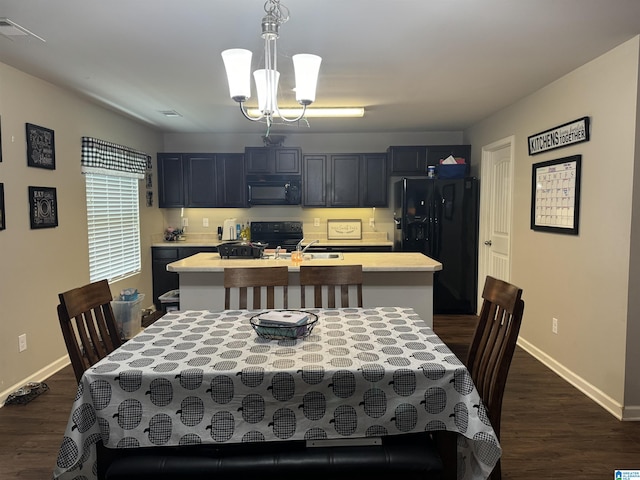 dining area with an inviting chandelier and dark hardwood / wood-style floors