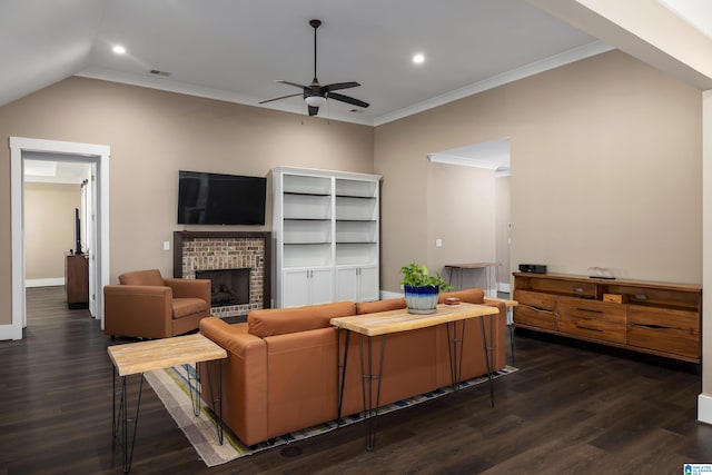 living room with ceiling fan, lofted ceiling, a fireplace, crown molding, and dark hardwood / wood-style flooring