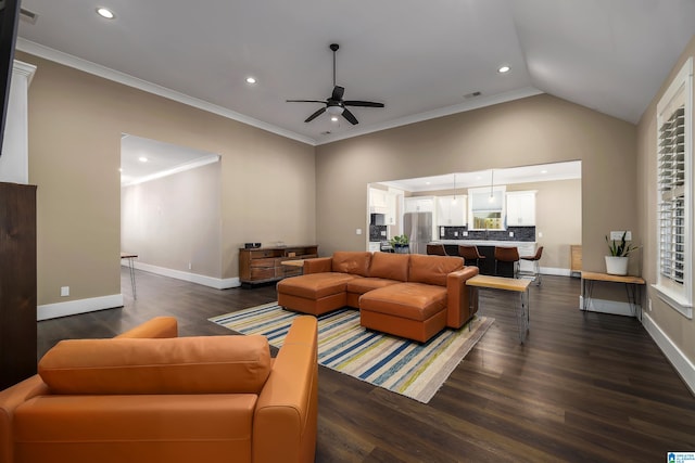 living room with lofted ceiling, dark hardwood / wood-style floors, ornamental molding, and ceiling fan