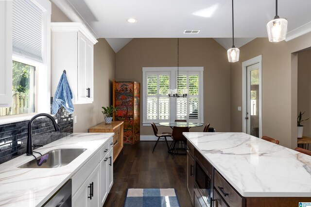 kitchen with pendant lighting, plenty of natural light, white cabinetry, and decorative backsplash