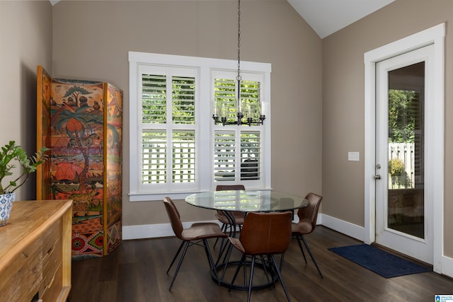 dining space featuring dark hardwood / wood-style floors and vaulted ceiling