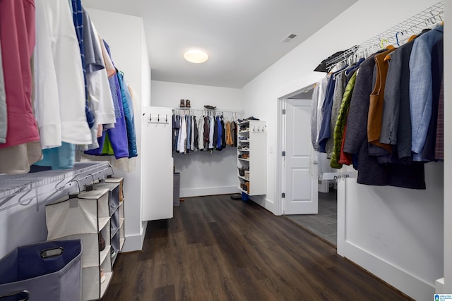 walk in closet featuring dark hardwood / wood-style floors