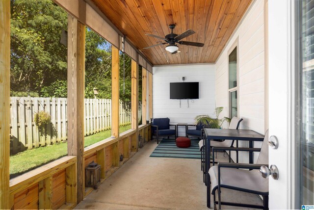 sunroom with ceiling fan and wood ceiling