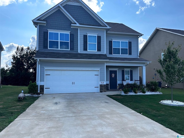 view of front of property with a front yard and a garage