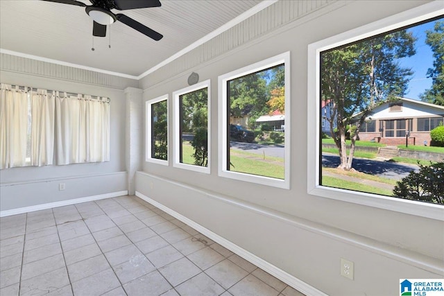 unfurnished sunroom featuring plenty of natural light and ceiling fan