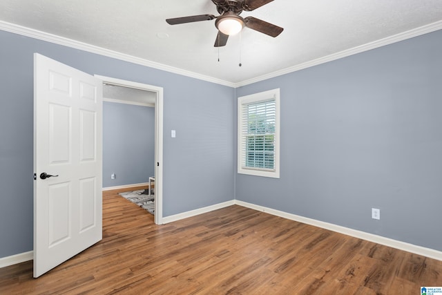 unfurnished bedroom featuring ornamental molding, ceiling fan, and hardwood / wood-style floors